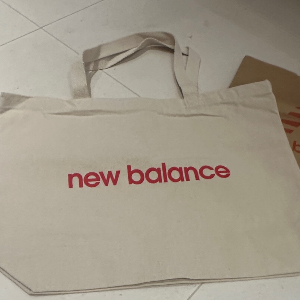 New Balance Beige Tote with Red Logo. Comes with a paper bag.